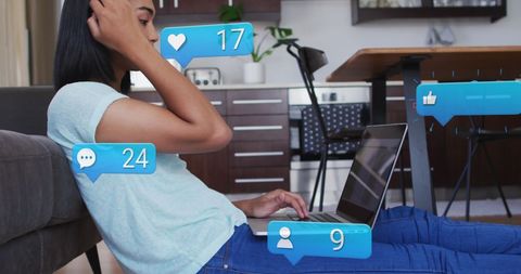 Young Woman Engaging with Social Media on Laptop at Home