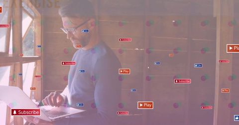 Man Engaging with Digital Technology in Bright Wooden Workspace