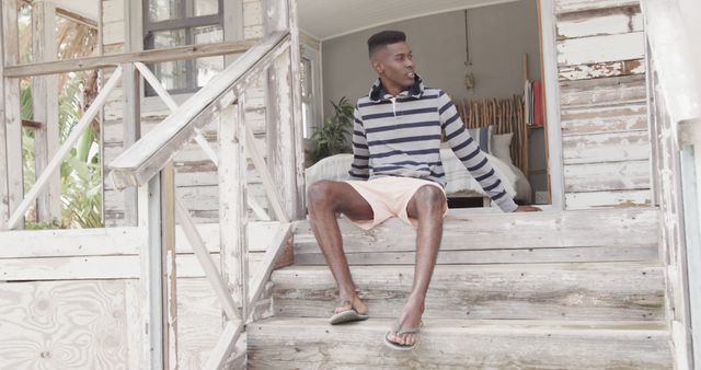 Man in Casual Clothing Sitting on Wooden Porch Steps - Download Free Stock Images Pikwizard.com