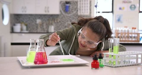 Young girl scientist conducting fun laboratory experiment