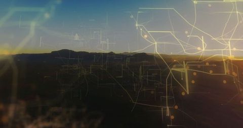 Digital networks across mountain silhouette at dawn