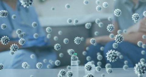 Covid-19 Cells and Vaccine Bottle in Medical Setting