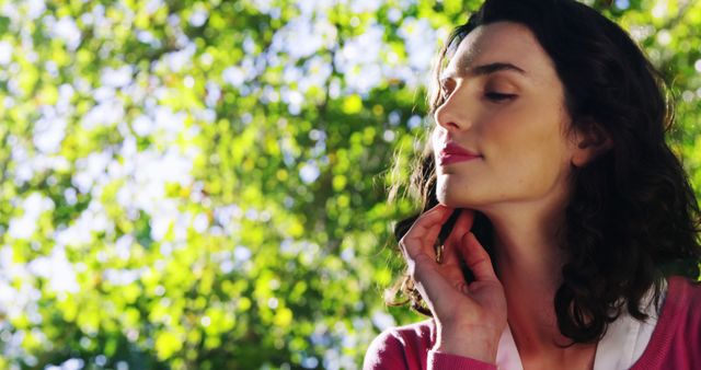 Woman Enjoying Nature with Eyes Closed in Sunlit Park - Download Free Stock Images Pikwizard.com