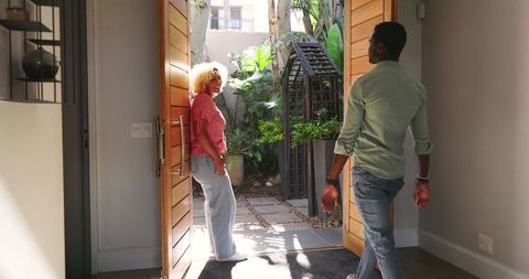 Couple celebrating engagement at front door