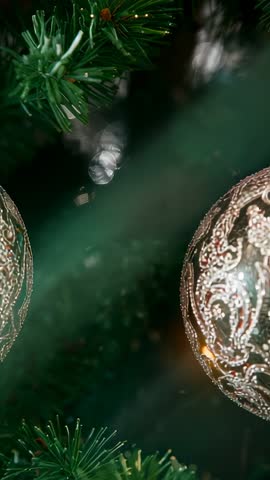 Panning Filigree Christmas Bauble on Fir Branch with Festive Bokeh Vertical Video