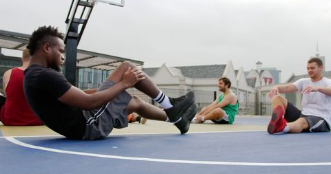 Diverse Basketball Team Doing Stretches on Outdoor Court - Download Free Stock Images Pikwizard.com