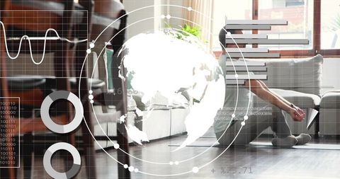 Casual man sitting on floor leaning against sofa using tablet with AR analytics overlays