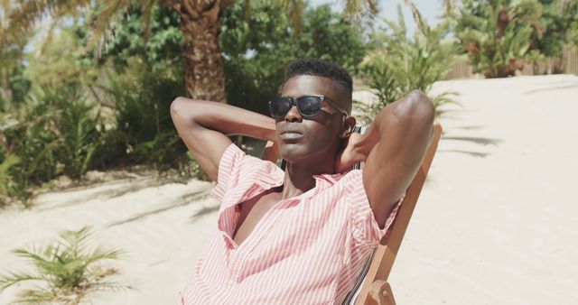 Relaxed Young Male in Sunglasses Enjoying Sunny Beach - Download Free Stock Images Pikwizard.com