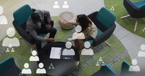 Diverse colleagues discussing in modern office setting