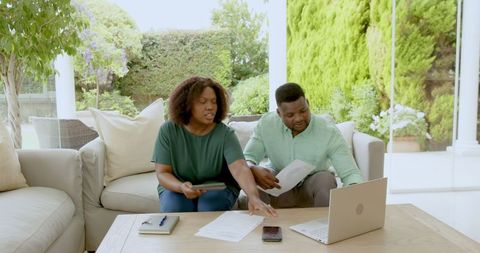Mature Couple Discussing Financial Plans on Outdoor Patio