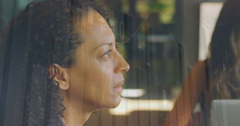 Side Profile of Businesswoman Amidst Digital Financial Graphs