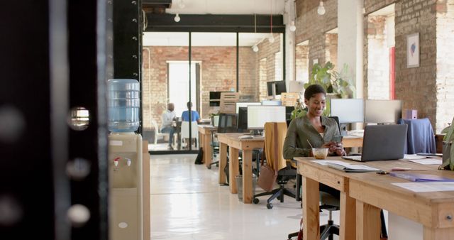 Businesswoman Working at Desk in Modern Open Office Space - Download Free Stock Images Pikwizard.com