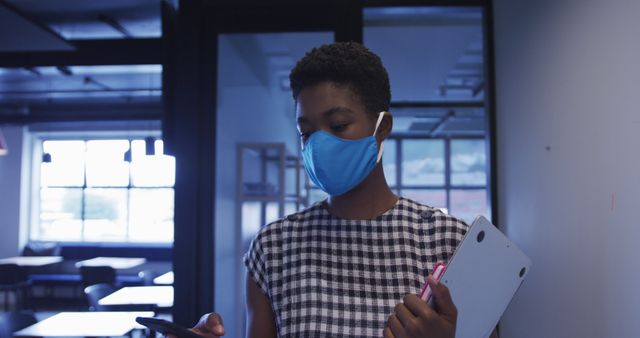 Professional Woman Wearing Mask and Holding Tablet in Office - Download Free Stock Images Pikwizard.com