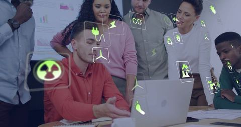 Diverse Team Collaborating on Sustainable Energy with Green Energy Icons Over Laptop