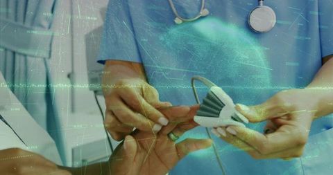 Healthcare technology: nurse using pulse oximeter with digital interface