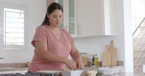Young Woman Preparing Healthy Meal in Modern Kitchen