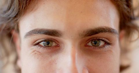 Close-up portrait highlighting green eyes and freckles