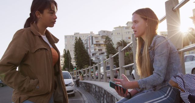 Teen Girls Having a Conversation Outdoors Near Urban Apartment Buildings - Download Free Stock Images Pikwizard.com