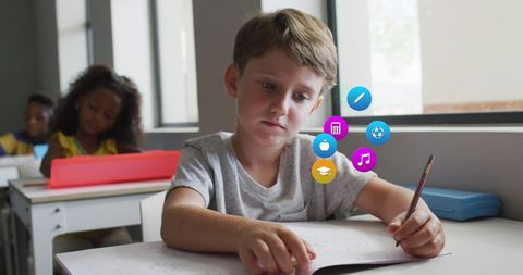 Engaged Schoolboy Studying with Educational Icons Overlay - Download Free Stock Images Pikwizard.com