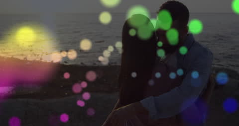 Romantic Embrace at Sunset with Colorful Lights