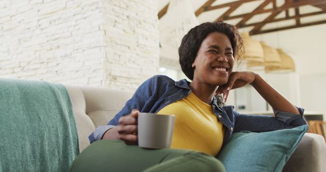 Smiling Woman Relaxing on Couch with Coffee Mug - Download Free Stock Images Pikwizard.com