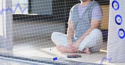 Mature asian man practicing mindful sitting by window with laptop phone and blue ui overlay