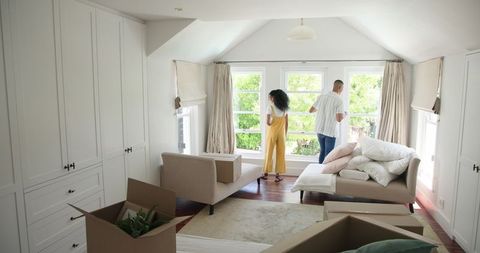 Diverse Couple Unpacking in Sunlit Living Room