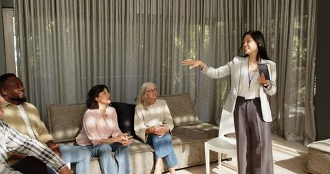 Asian female therapist leading engaged group therapy session