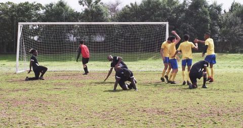 Intense soccer match players forming defensive wall on field