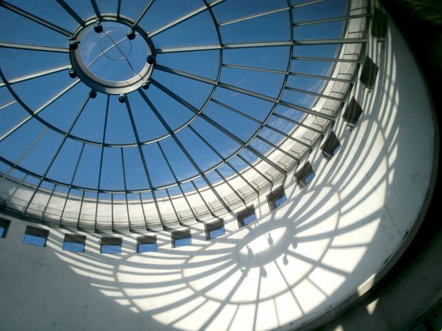 Glass dome presenting intricate shadow patterns on interior surfaces. Useful for depicting modern architecture, design concepts, and structural aesthetics. Ideal for architectural portfolios, design magazines, and educational materials on construction and modern architecture.