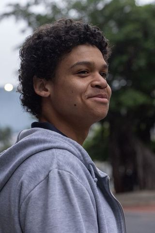 African american man smiling in gray hoodie on urban street portrait outdoor headshot