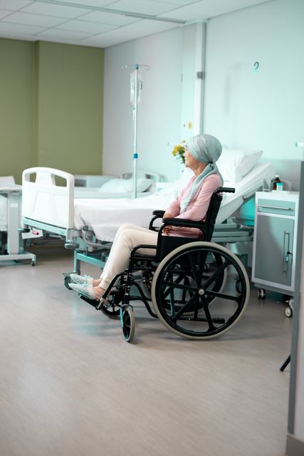 Happy senior caucasian female patient in wheelchair sitting in hospital ward smiling, copy space. Medical services, hospital and healthcare concept.