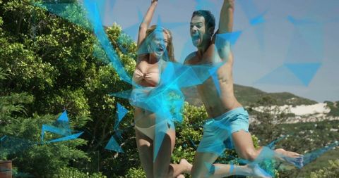 Young couple jumping on coastal dunes with blue geometric overlay