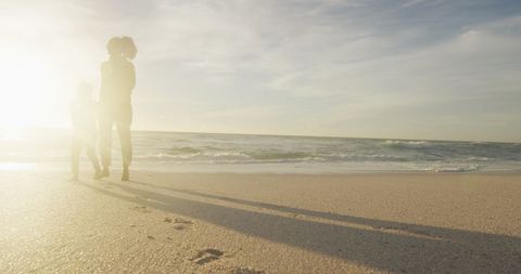 Silhouette of Mother and Daughter Walking on Tropical Beach at Sunset - Download Free Stock Images Pikwizard.com