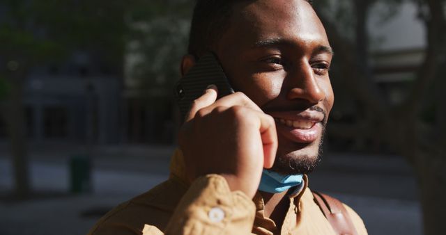 Happy Man Talking on Phone Outdoors on Sunny Day - Download Free Stock Images Pikwizard.com