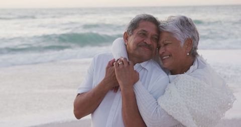 Senior Couple Embracing on Beach Moment of Love and Happiness