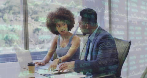 Diverse Coworkers Analyzing Financial Reports in Modern Office