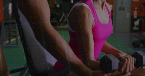 Personal Trainer Spotting Client During Bicep Curl at Gym