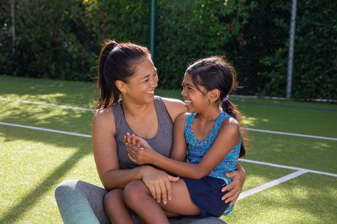Mother and daughter enjoying quality time on outdoor sports court