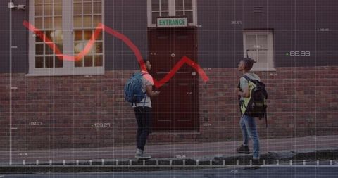 Two young people chatting and checking phone by brick entrance with market chart overlay