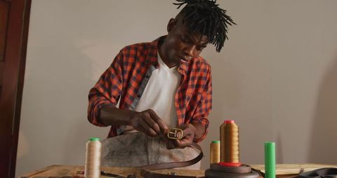 Skilled artisan crafting handcrafted leather belt with precision