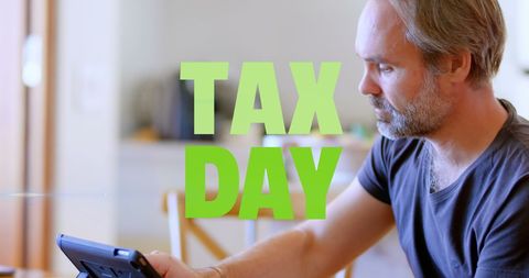 Focused middle-aged man calculating taxes on tax day