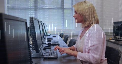 Midadult woman typing at workstation with data chart overlay for analytics training