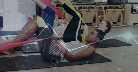 Women Engaging in Resistance Band Pilates Workout for Fitness and Well-Being