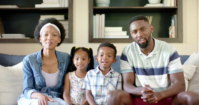 Happy African American Family Sitting on Couch and Smiling at Camera - Download Free Stock Images Pikwizard.com