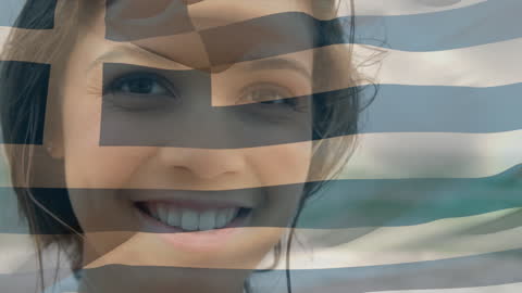 Smiling Woman with Greece Flag Overlapping Her Face by the Beach