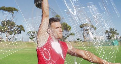 Athlete lifting dumbbell overhead with augmented reality fitness interface on field