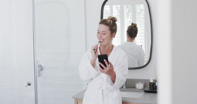 Woman Brushing Teeth in Bathroom Using Smartphone - Download Free Stock Images Pikwizard.com