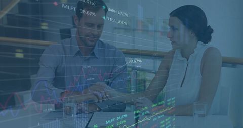 Business professionals analyzing stock data overlaid with graphs