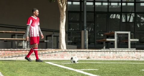 Young Soccer Player Focusing on Ball Control on Field